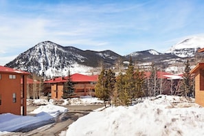 A snowy mountain landscape with buildings featuring red roofs.
