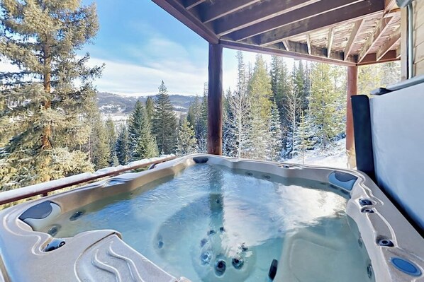 A hot tub with a clear view of snow-covered trees and mountains in the background. - Well-appointed home with home theater, radiant heat & private hot tub (Fraser)