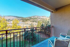 A balcony with a view of a mountainous landscape, a chair, and a railing. - Charming mountain condo w/Vail Pass views, gas fireplace, deck, & shared hot tub (Copper Mountain)