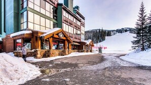 A building with a wooden facade, a stone base, and a sign that reads 'ENTAL'S.' - Dog-friendly, ski condo with golf course views, balcony, hot tub & sauna (Copper Mountain)