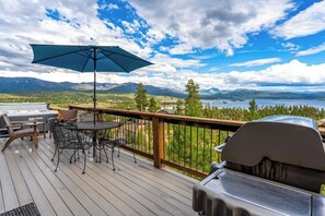 A deck with a grill, outdoor furniture, and a view of mountains and a lake. - Large mountain home with epic views, hot tub, &  gas fireplace (Grand Lake)