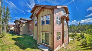 A multi-story residential building with a sloped roof, large windows, and a well-maintained lawn. - Convenient Mountain Condo w/Free WiFi, Mtn Views, Private Washer/Dryer, & Cable (Fraser)
