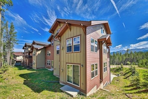 A multi-story residential building with a sloped roof, large windows, and a well-maintained lawn. - Convenient Mountain Condo w/Free WiFi, Mtn Views, Private Washer/Dryer, & Cable (Fraser)