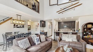 A spacious living area with a high ceiling, a dining area, and a kitchen. - Handsome Condo w/WiFi, Deck, Shared Pool, Hot Tub, & Sauna - 2 Miles to Keystone (Keystone)