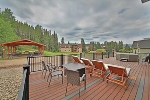 A deck with outdoor furniture, a gazebo, and a view of surrounding buildings and trees. - Updated condo in heart of downtown Winter Park with hot tubs & pool (Winter Park)