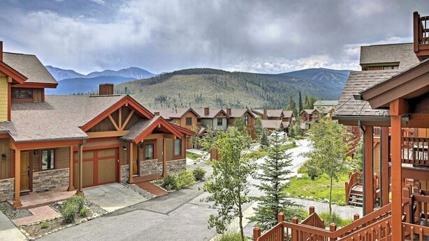 A resort with multiple wooden cabins, a central paved area, and a mountain backdrop. - Spacious home w/ kitchen, wifi, great views, deck & convenient location (Winter Park)