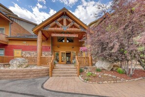 A lodge with a wooden facade, a porch with steps, and a sign that reads 'Hidden River Lodge.' - Walk to the Slopes, Amazing Ski Area Views, Shared Hot Tubs Too (Keystone)