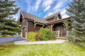 A two-story house with a front porch, a driveway, and a well-maintained lawn. - Attractive & Spacious Countryside Home w/Firepit, Private W/D, Free WiFi, Patio (Granby)