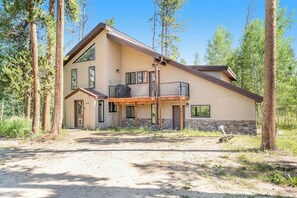A two-story house with a balcony, surrounded by trees. - Two-story dog-friendly getaway with WiFi, wood-burning fireplace, & washer/dryer (Fraser)
