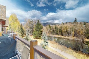 A balcony with a view of a river, trees, and distant mountains. - End-Unit Condo w/Beautiful Blue River & Mountain Views, Free WiFi, & Deck (Silverthorne)