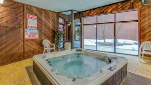 A spa area with a hot tub, wooden walls, and a sign warning of no lifeguard on duty. - Cozy Lakeside Condo with Hot Tub, Pool, Stunning Views & Ski Resort Access (Dillon)