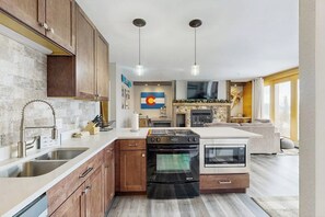 A modern kitchen with a built-in oven, a microwave, and a dishwasher. - Cozy condo with fireplace, pool, & hot tub - near trails (Silverthorne)