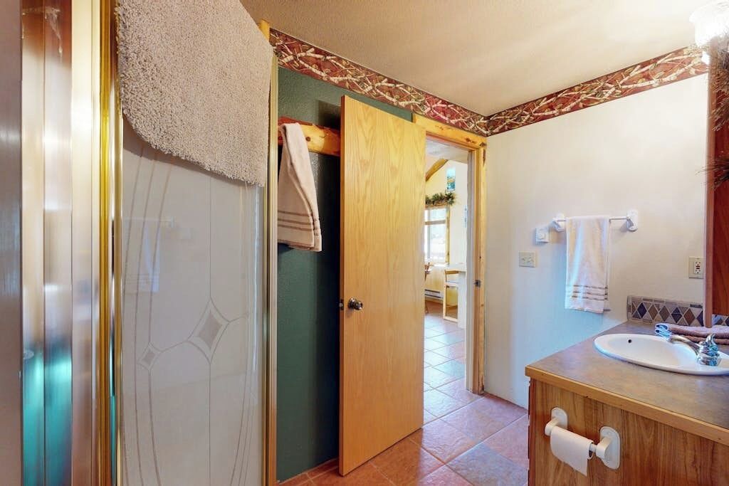 A bathroom with a shower, a sink, and a toilet.