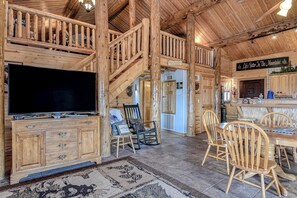 A wooden interior with a TV, dining area, and kitchen. - Remodeled, Dog-Friendly Cabin w/ Large Fenced Yard, WiFi & W/D - Great for ATVs (South Fork)