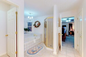A bathroom with a bathtub, a shower, and a toilet. - Posh mansion with antique decor, WiFi, & gas fireplace - near river and skiing (South Fork)