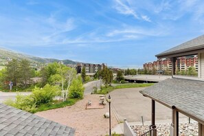 A hotel with a covered outdoor area, a paved courtyard, and a view of surrounding buildings and hills. - Luxury home one block from gondola w/mountain views, free WiFi, & private W/D (Steamboat Springs)