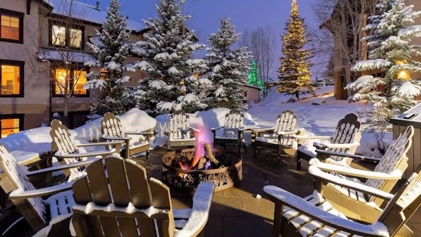 A snow-covered outdoor seating area with Adirondack chairs and a fire pit. - 1410 EagleRidge Multi-level townhome with AC, fireplace, pool & hot tubs - walk to the gondola (Steamboat Springs)