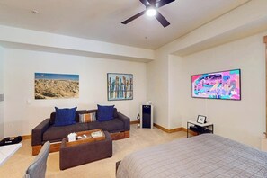A modern hotel room with a bed, a sofa, a coffee table, and artwork on the walls. - EagleRidge Lodge 312-to-gondola studio with hot tubs, pool, fitness room, and ski shuttle (Steamboat Springs)