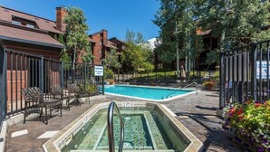 A swimming pool with a 3 FT depth marker, surrounded by outdoor seating and a fence. - Timber Run 313 - Lovable condo with pool, hot tubs, sauna & clubhouse (Steamboat Springs)