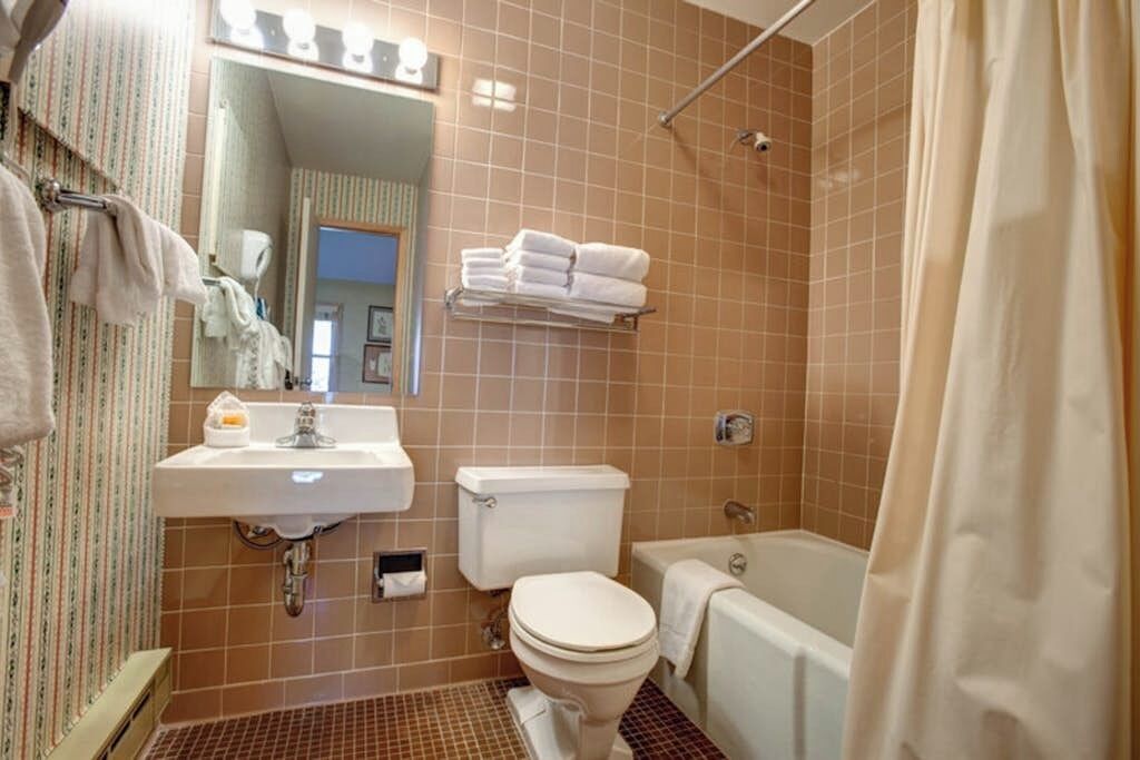 A bathroom with a sink, toilet, and bathtub.
