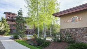 A building with a sign reading 'Canyon Creek at Eagle Ridge.' - Canyon Creek B207 - Modern family getaway w/ a pool, pool spa, garage parking - walk to the gondola (Steamboat Springs)