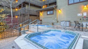 A hotel with a hot tub, outdoor seating, and a balcony. - Steamboat Springs condo with pool, hot tub & balcony (Steamboat Springs)