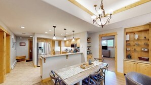 A spacious kitchen with wooden cabinets, a central island, and pendant lighting. - Canyon Creek B306 - Spacious condo with pool, hot tub, gym & easy walk to lifts (Steamboat Springs)