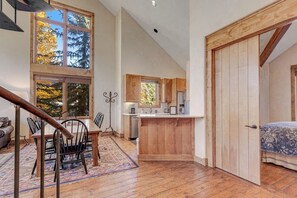 A loft-style room with a dining area, kitchen, and sleeping area. - Fantastic, ski-in/out condo with patio, fireplace, grill & Washer/Dryer (Mountain Village)