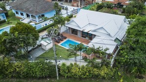 A residential property with a swimming pool, a covered patio, and a fenced yard. - NEW Tulip 4 Bedroom Pool Villa  Chalong Phuket (Chalong)