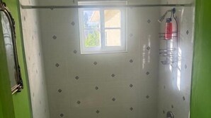 A bathroom with a shower, a sink, and a toilet.
