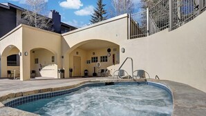 A spa area with a hot tub, seating, and a covered patio. - Beaver Creek West Condo with Heated Pool, 3 Hot Tubs & Shuttle to the Slopes (Avon)