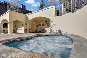 A spa area with a hot tub, seating, and a covered patio. - Beaver Creek West Condo with Heated Pool, 3 Hot Tubs & Shuttle to the Slopes (Avon)