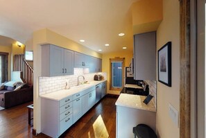 A modern kitchen with white cabinets, a built-in microwave, and a countertop with a coffee machine. - Spacious Townhome with Hot Tub, Adjacent to Gore Creek | 4.5 Miles to Vail (Vail)