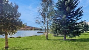 A grassy area with trees and a lake. - Comfy condo w/hot tub, pool & sauna access- free shuttle to slopes, walk to lake (Avon)