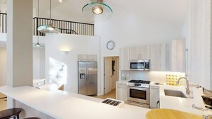A modern kitchen with a large island, stainless steel appliances, and a glass ceiling light. - Springs of Arrowhead Getaway w/ Deck, Pool, Hot Tub & Village Shuttle (Edwards)