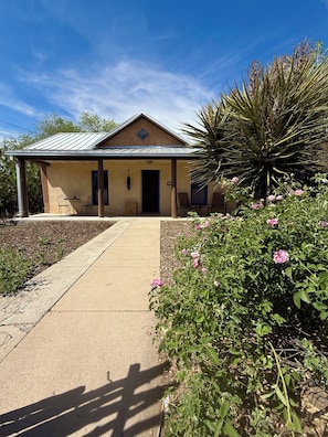 A single-story building with a covered porch, a door, and a small window. - Railyard Rose: explore Santa Fe on foot from this central oasis (Santa Fe)