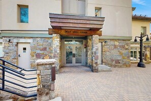 A stone facade with a wooden overhang and a sign reading 'BLUE MESA LODGE.' - Luxury ski in ski out condo w/ fast wifi, ski locker & great location (Mountain Village)