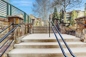 A set of stone steps with metal railings leading to a building entrance. - Luxury ski in ski out condo w/ fast wifi, ski locker & great location (Mountain Village)