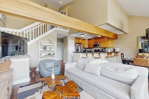 A spacious living area with a white sofa, wooden coffee table, and a staircase leading to an upper level. - Spacious mountain retreat minutes from Beavercreek w/shared pool/hot tub & patio (Edwards)