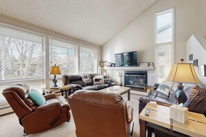 A living room with a fireplace, two sofas, a recliner, and a coffee table. - Conveniently located condo w/ full kitchen & fast wifi - near skiing and golf (Avon)