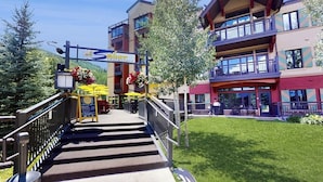 A multi-story building with a restaurant sign, outdoor seating, and a staircase leading to the entrance. - Ski-in/out, riverfront studio w/ alpine view, fast WiFi, shared pool/hot tubs/WD (Vail)
