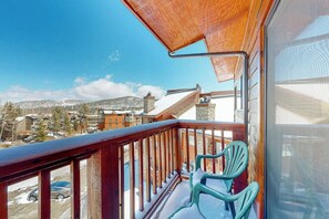 A balcony with a view of a snowy landscape and buildings. - Ski-in/out gold-rated condo with hot tubs, fireplace & gym (Breckenridge)
