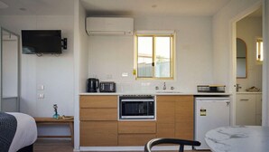 A compact kitchen with a microwave, coffee maker, and a small refrigerator. - Clyde B 13 - Family Cabin Sleeps 6 with Bunks (Mollymook)