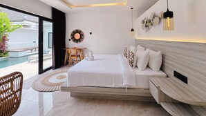 A modern bedroom with a large bed, a desk, and a view of a swimming pool. - Canggu Luxury Villa – Private Pool (Badung)