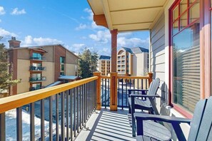 A balcony with a view of other buildings, a railing, and outdoor furniture. - Walk to lifts from this centrally located condo with a pool, hot tubs & gym (Breckenridge)
