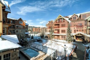 A resort with multiple buildings, a central courtyard, and a pool. - Luxury condo near Peak 9 base with outdoor pool, hot tubs & gym (Breckenridge)