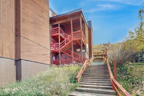A wooden building with a staircase leading to a red balcony. - Ski In on Crested Butte Mountain, Free Shuttle, Great Views, Renovated (Crested Butte)