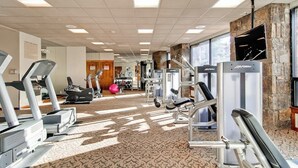 A gym with treadmills, elliptical machines, and weight equipment. - Main Street condo with mountain view, fireplace, pool & hot tubs - walk to lifts (Breckenridge)