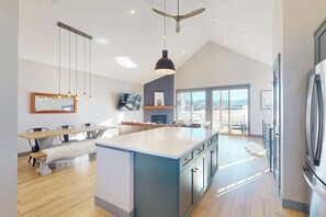A modern kitchen with a large island, pendant lighting, and a view to the outside. - Relax, Recharge, and Explore – Your Perfect Mountain Retreat in Granby, CO (Granby)