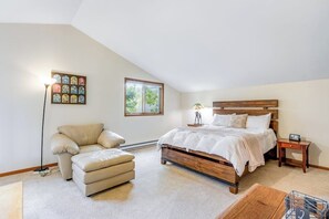 A bedroom with a bed, a chair, a lamp, a picture on the wall, and a window. - Mountain House + Loft w/Free WiFi, Enclosed Patio, Gas Grill, Cable (Silverthorne)